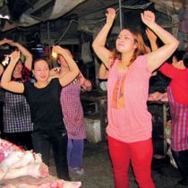 Shoppers dance with the butchers in Vietnam market 
