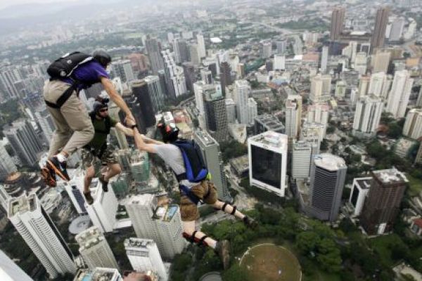 A base jumper leaps from the 380m-high Kuala Lumpur Tower